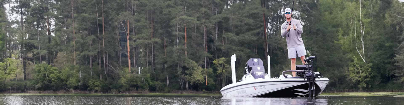 man fishing on a boat in a lake