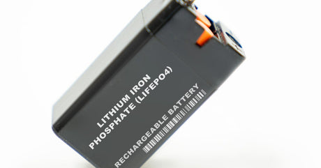 A black battery displays the words "Lithium Iron Phosphate (LIFEPO4) Rechargeable Battery" in white.