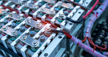 Several groups of wired lithium batteries connected by metal tabs bolted into each battery terminal.