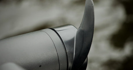 A close-up of a trolling motor propeller. The motor and propeller are both black, but only the propeller is glossy.